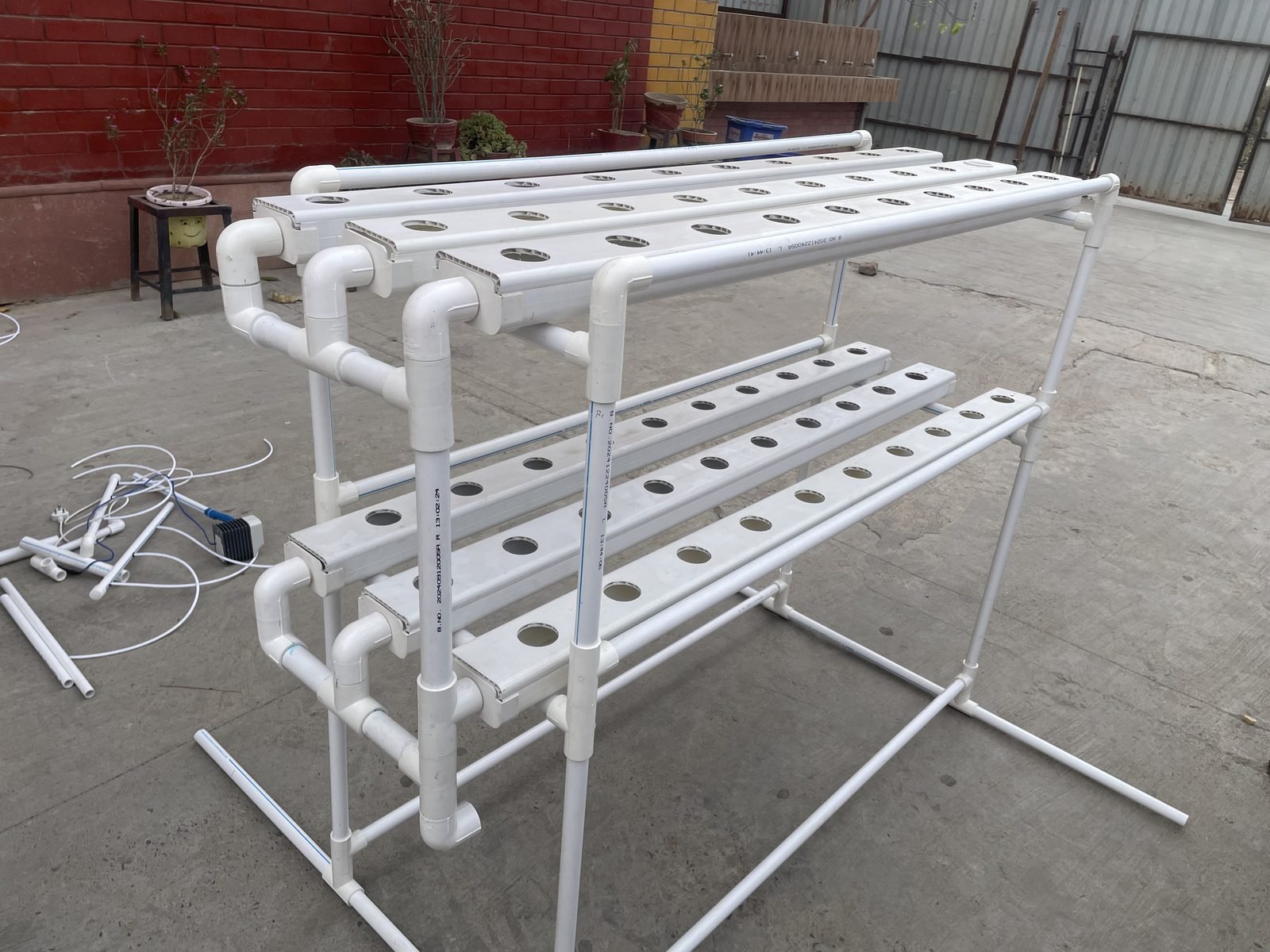 NFT hydroponic system frame with PVC channels and pipes